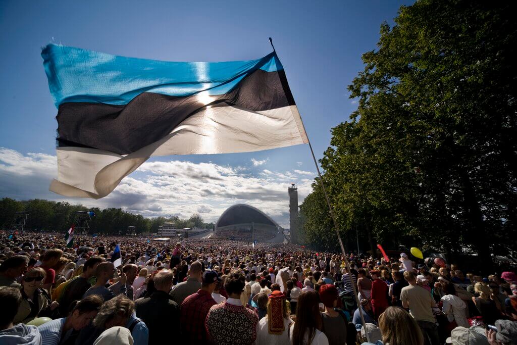 Estonian flag over the crowd at the Song Festival: where Estonian language songs are performed by choirs, bands and orchestras